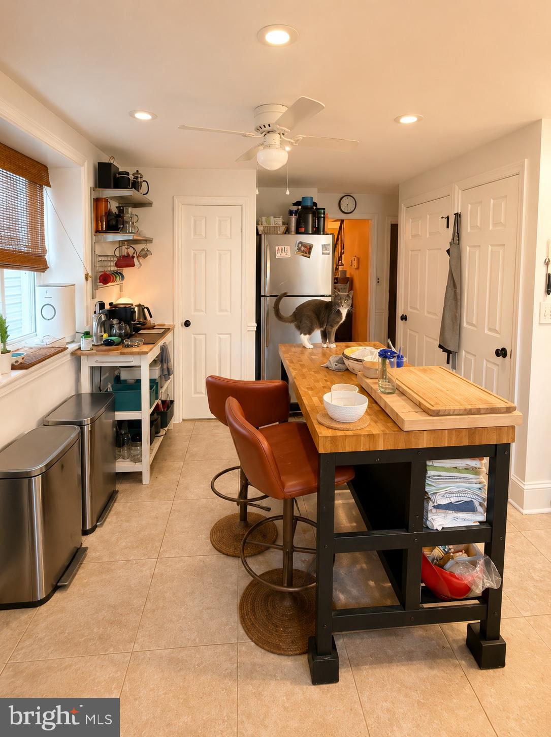 22 Balligomingo Road Conshohocken, PA 19428 - Photo 8 of 35 a kitchen with stainless steel appliances kitchen island granite countertop a table chairs and a refrigerator