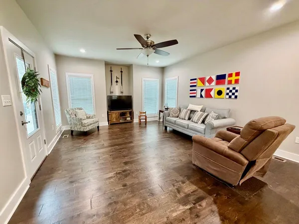 a living room with furniture and wooden floor