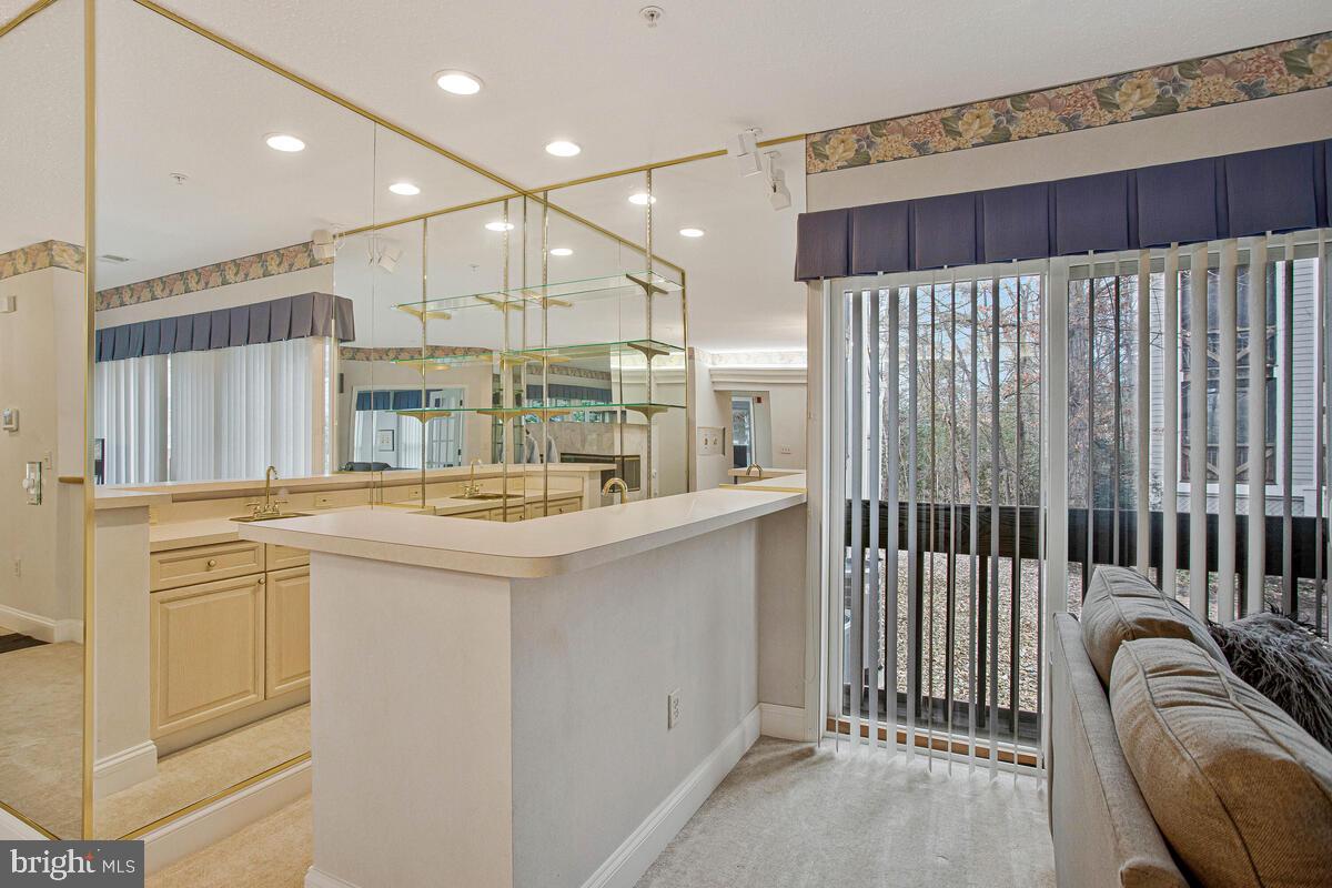 501 Runabout Loop, Unit 501 Solomons, MD 20688 - Photo 15 of 36 a kitchen with stainless steel appliances granite countertop a sink and a refrigerator