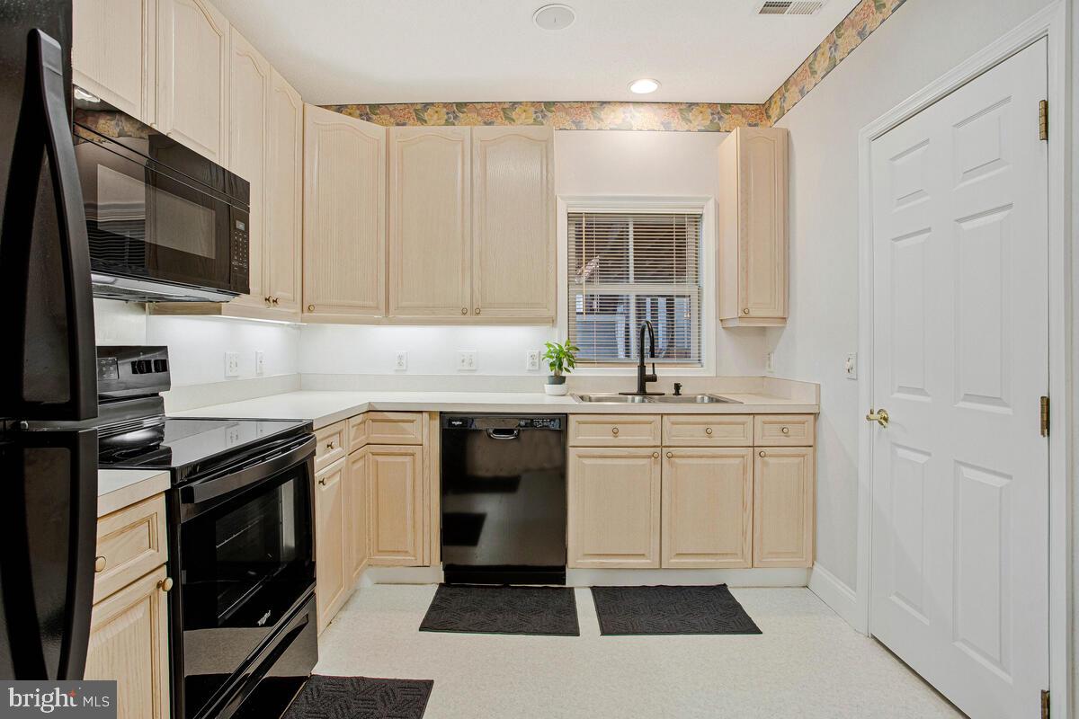 501 Runabout Loop, Unit 501 Solomons, MD 20688 - Photo 16 of 36 a kitchen with a sink stove and microwave
