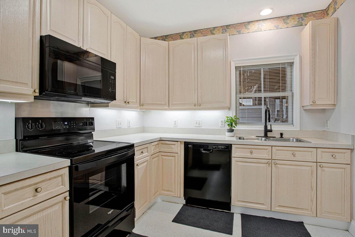 501 Runabout Loop, Unit 501 Solomons, MD 20688 - Photo 17 of 36 a kitchen with a sink stove and microwave