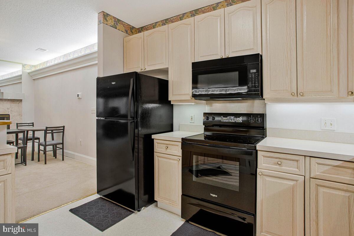 501 Runabout Loop, Unit 501 Solomons, MD 20688 - Photo 18 of 36 a kitchen with a refrigerator stove and microwave