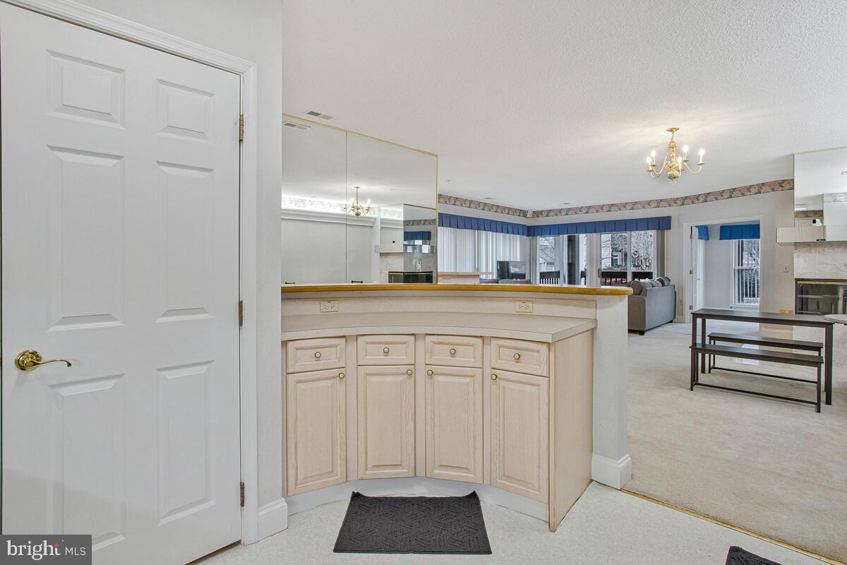 501 Runabout Loop, Unit 501 Solomons, MD 20688 - Photo 20 of 36 a kitchen with white cabinets and sink