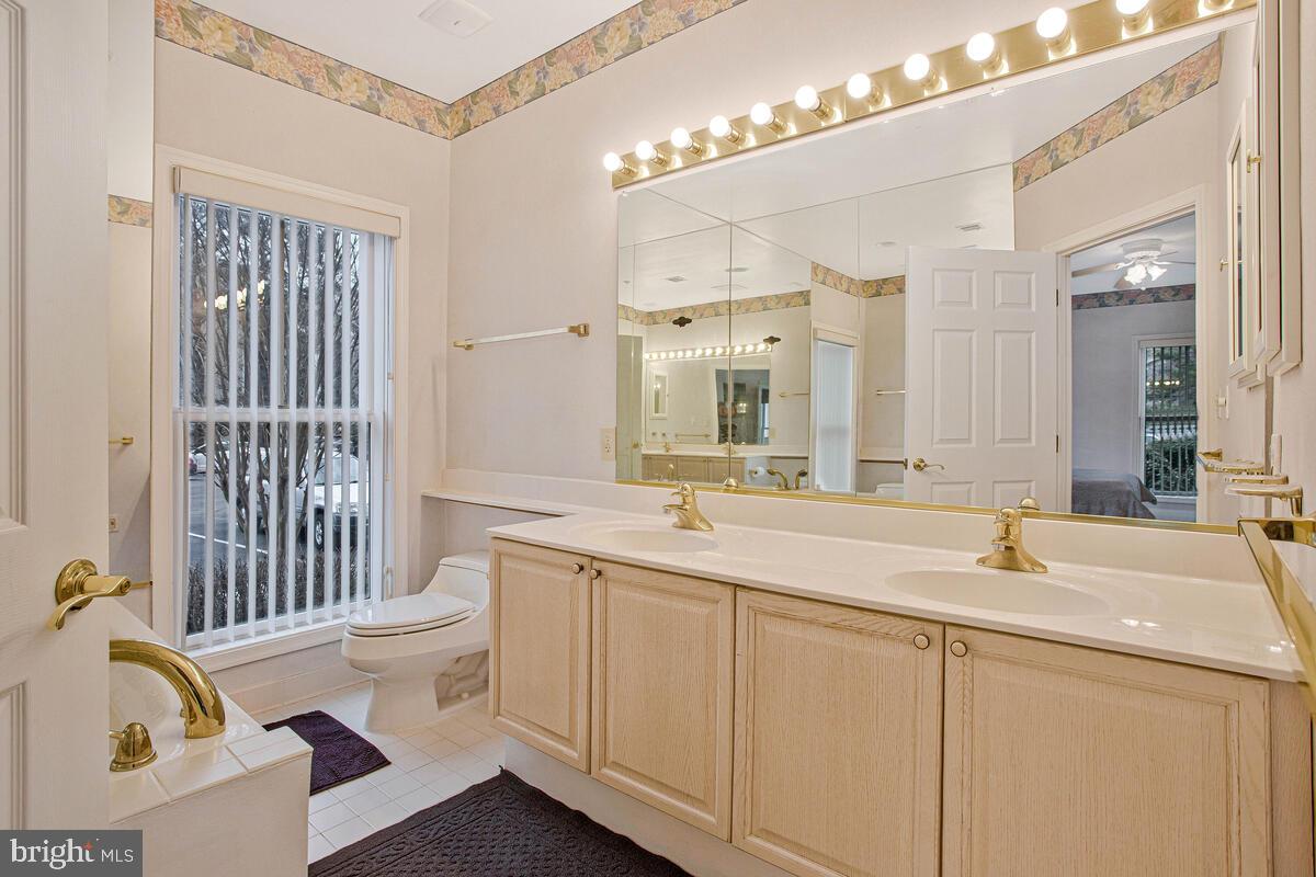 501 Runabout Loop, Unit 501 Solomons, MD 20688 - Photo 24 of 36 a bathroom with a sink and a mirror