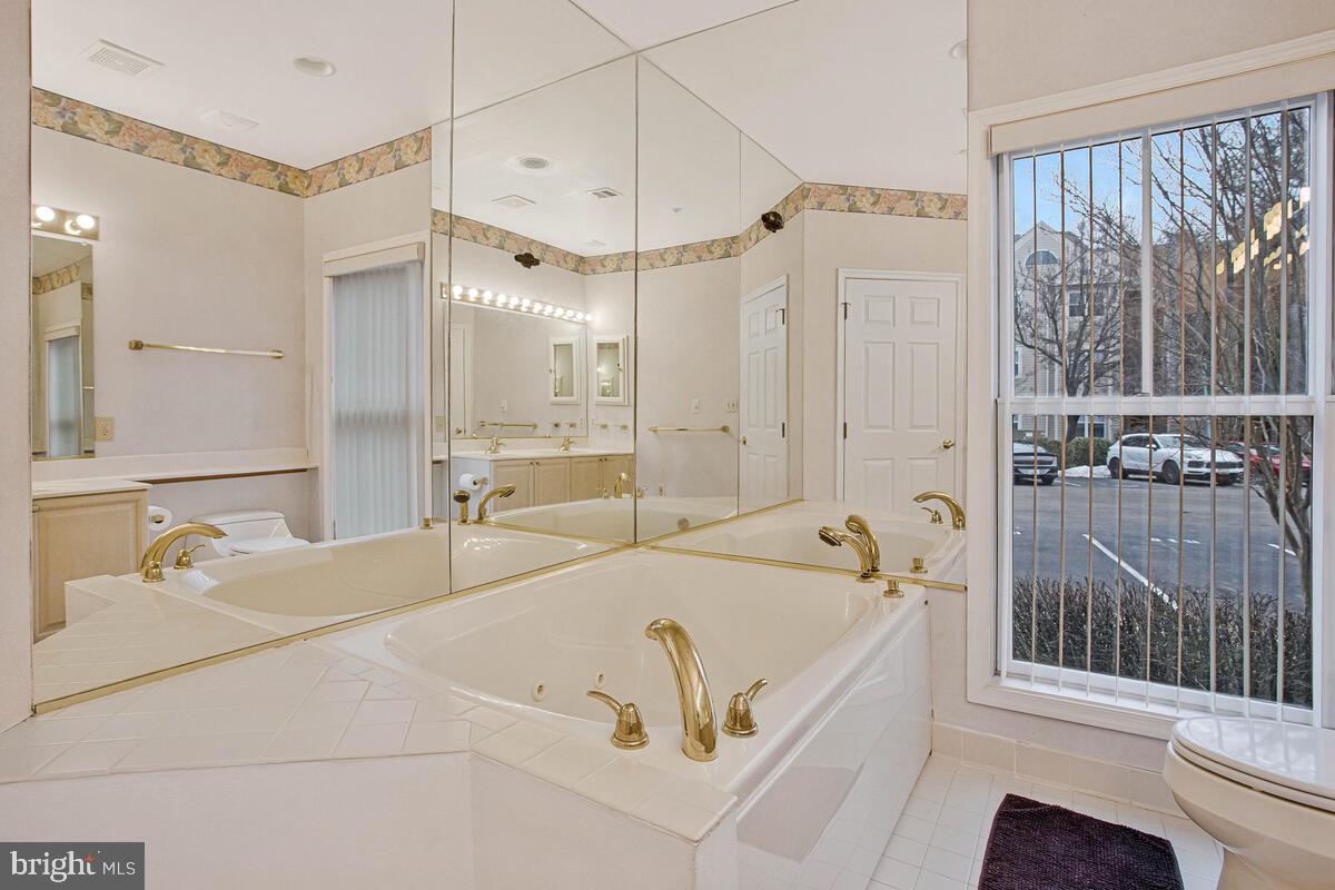 501 Runabout Loop, Unit 501 Solomons, MD 20688 - Photo 25 of 36 a bathroom with a tub a sink and a shower