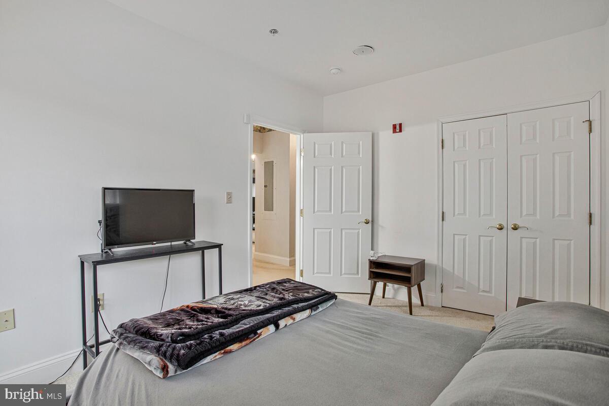 501 Runabout Loop, Unit 501 Solomons, MD 20688 - Photo 27 of 36 a bedroom with a bed and a television in it