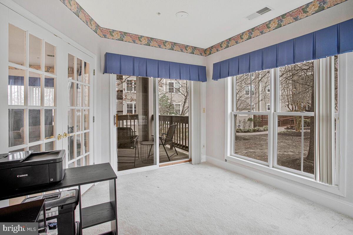 501 Runabout Loop, Unit 501 Solomons, MD 20688 - Photo 30 of 36 a view of a room with wooden floor and furniture