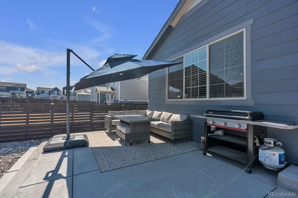 a backyard of a house with outdoor seating
