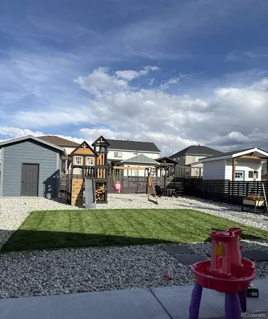 a front view of a house with a yard fire pit and outdoor seating
