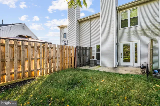 a view of a backyard with wooden fence
