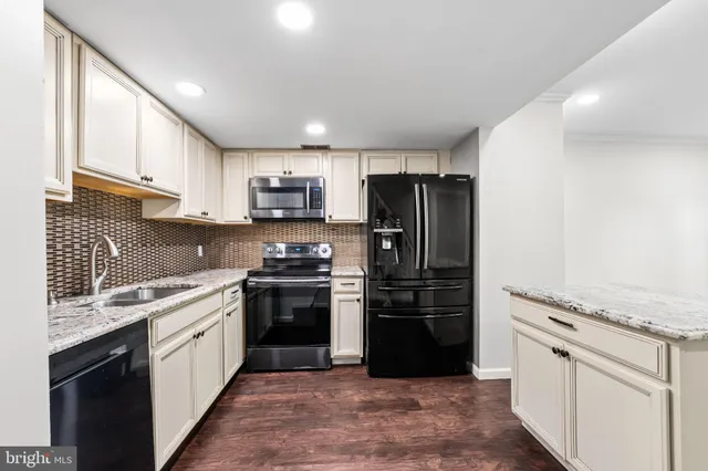 a kitchen with a refrigerator stove and sink