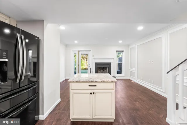 a view of kitchen with sink refrigerator and window