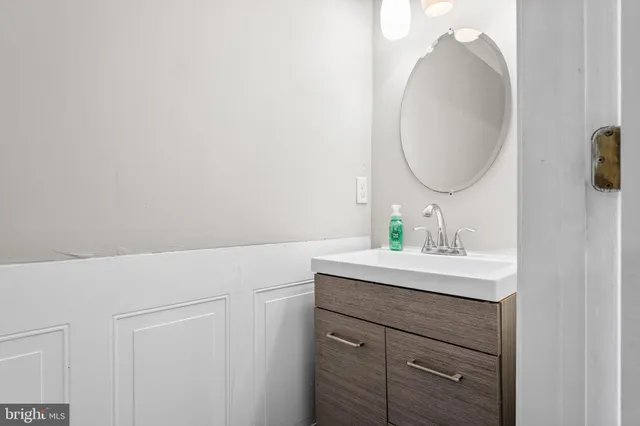 a bathroom with a sink vanity and a mirror