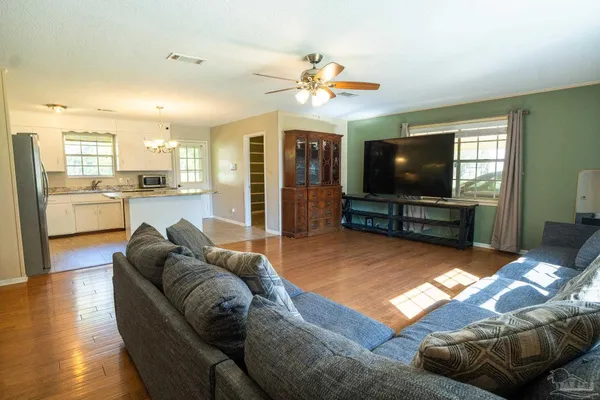 a living room with furniture and a flat screen tv
