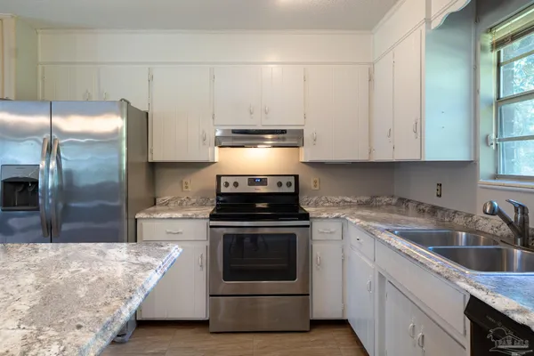 a kitchen with a stove and a refrigerator