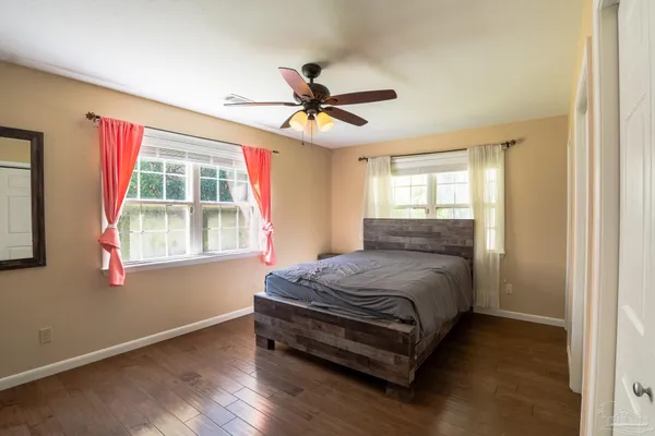 a bed sitting in a room next to a window
