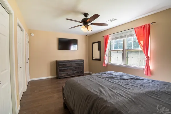 a bedroom with a bed and a flat screen tv