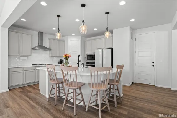 a view of a dining room with furniture wooden floor and chandelier