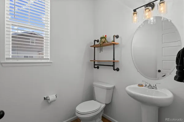 a bathroom with a sink mirror and toilet