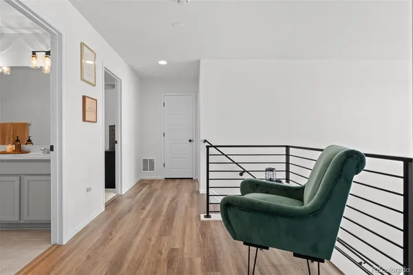 a view of a hallway with couch and wooden floor