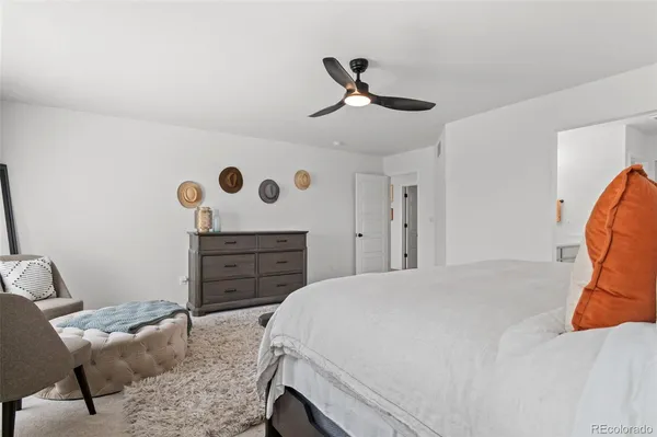 a bed room with a bed and a chair