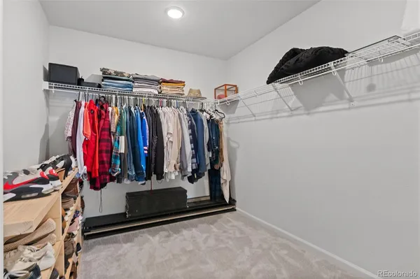 a view of walk in closet with clothes