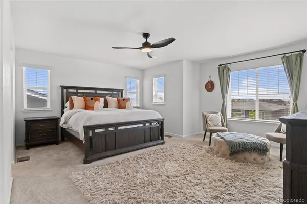 a bedroom with a bed a table and chair