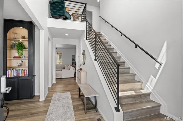 a view of entryway and hall with wooden floor