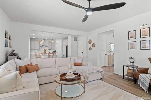 a living room with furniture and a wooden floor