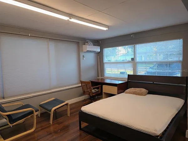 a room with wooden floor and furniture