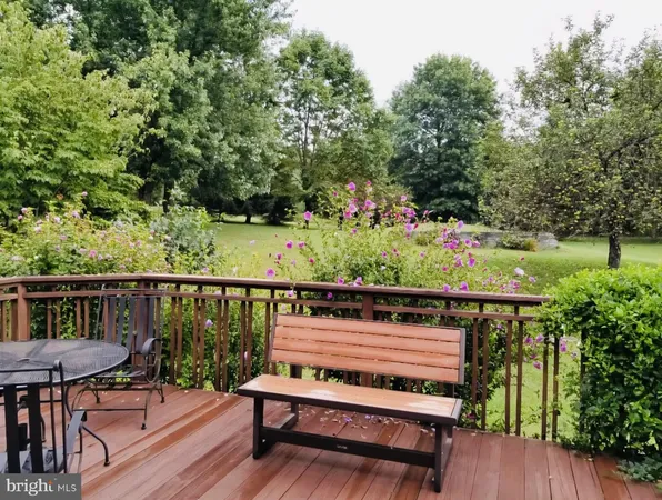 a view of a balcony with wooden floor and outdoor seating