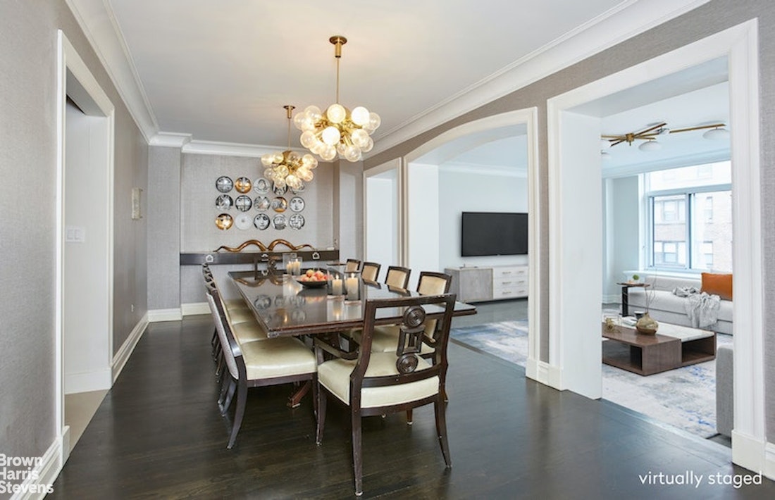 525 East 80th Street, Unit 7BC Manhattan, NY 10075 - Photo 1 of 13 a view of a dining room with furniture a chandelier and wooden floor