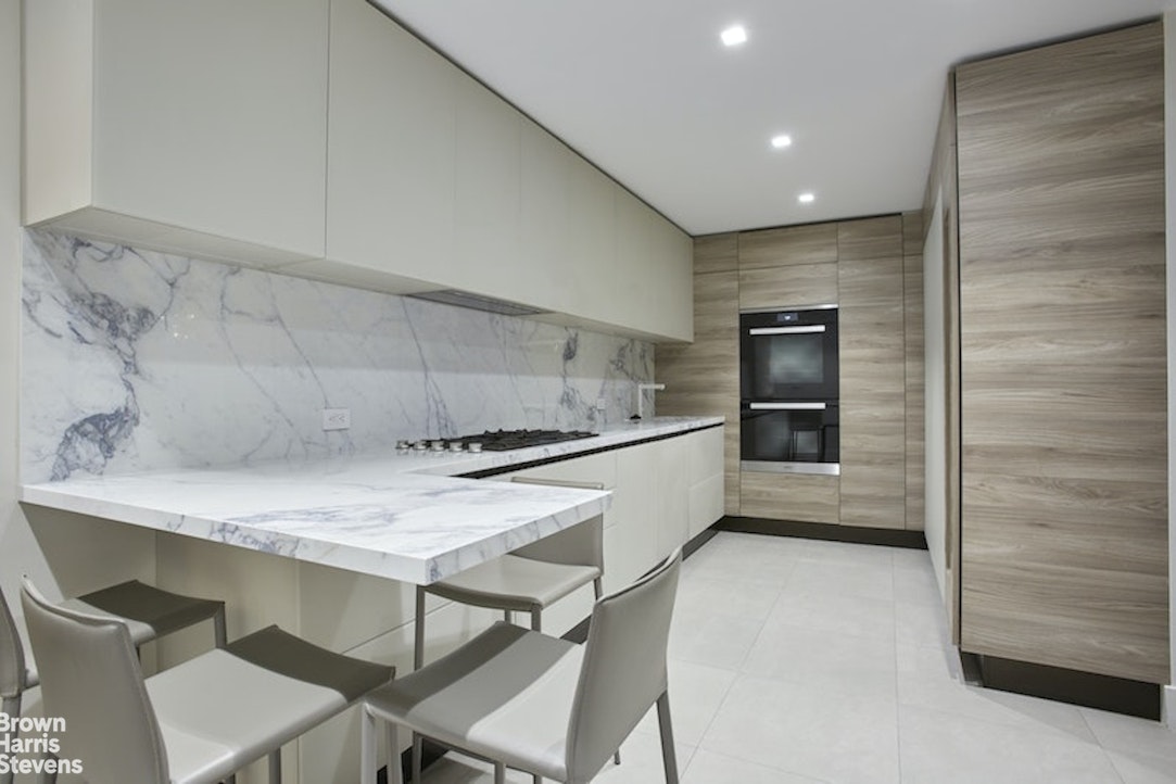 525 East 80th Street, Unit 7BC Manhattan, NY 10075 - Photo 3 of 13 a kitchen with a table and chairs