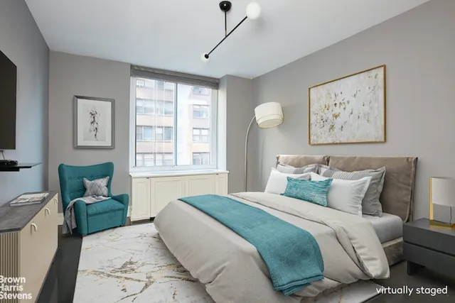 a bedroom with bed and a couch