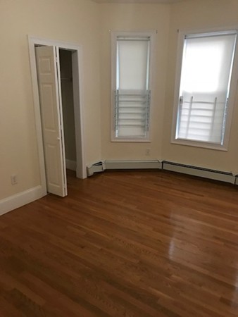 14 Schiller Street, Unit 2 Boston, MA 02130 - Photo 6 of 12 an empty room with wooden floor and windows