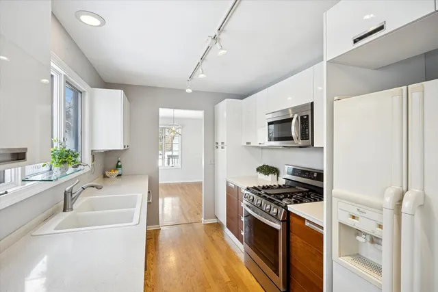 a kitchen with stainless steel appliances a stove sink and microwave