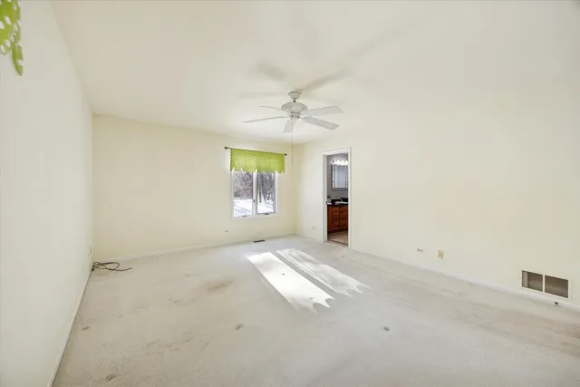 an empty room with windows and entrance