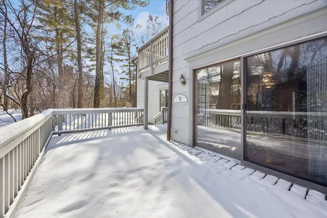 a view of a porch with wooden floor and fence