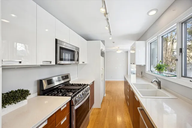 a kitchen with a stove a sink and a refrigerator