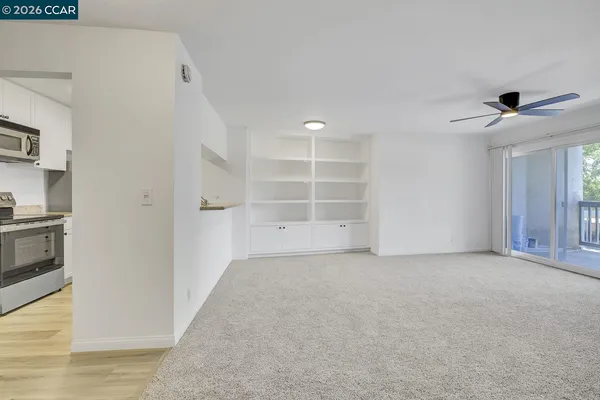 a view of an empty room with a ceiling fan