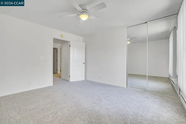 a view of an empty room and closet area