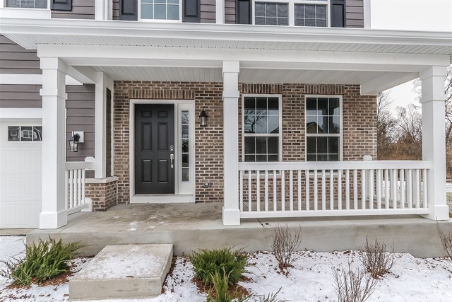 1228 Declan Court, Unit 4 Naperville, IL 60563 - Photo 2 of 32 a front view of a house with a garden