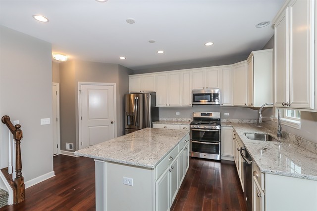 1228 Declan Court, Unit 4 Naperville, IL 60563 - Photo 12 of 32 a kitchen with stainless steel appliances granite countertop a sink stove and refrigerator