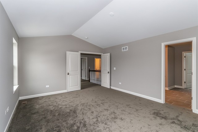1228 Declan Court, Unit 4 Naperville, IL 60563 - Photo 18 of 32 a view of an empty room with window and closet area