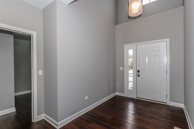 1228 Declan Court, Unit 4 Naperville, IL 60563 - Photo 3 of 32 an empty room with wooden floor
