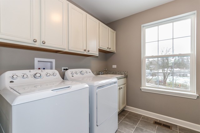 1228 Declan Court, Unit 4 Naperville, IL 60563 - Photo 22 of 32 a utility room with dryer and washer