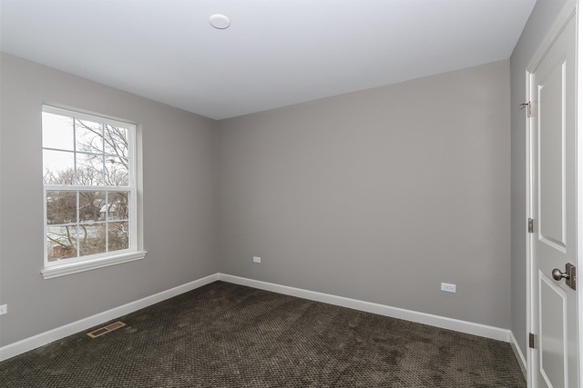 1228 Declan Court, Unit 4 Naperville, IL 60563 - Photo 28 of 32 an empty room with a window