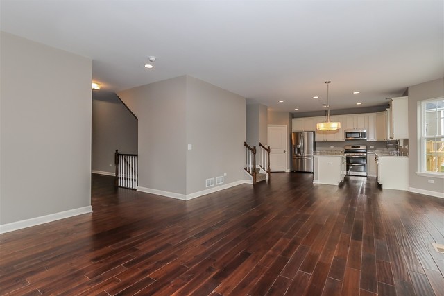1228 Declan Court, Unit 4 Naperville, IL 60563 - Photo 7 of 32 a view of kitchen with cabinets and wooden floor
