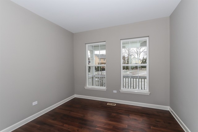 1228 Declan Court, Unit 4 Naperville, IL 60563 - Photo 8 of 32 a view of an empty room with wooden floor and a window