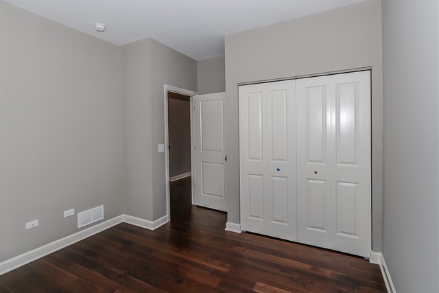 1228 Declan Court, Unit 4 Naperville, IL 60563 - Photo 9 of 32 a view of an empty room with wooden floor